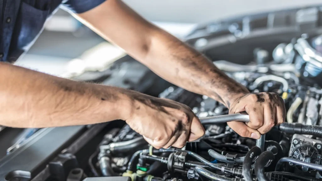 A mechanic working on a car's engine.