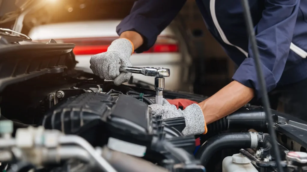 A mechanic slowly repairing a defective car.
