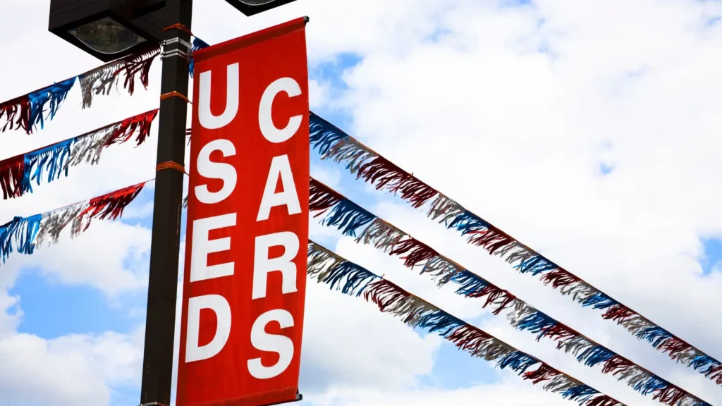 A close up of a used car lot sign.