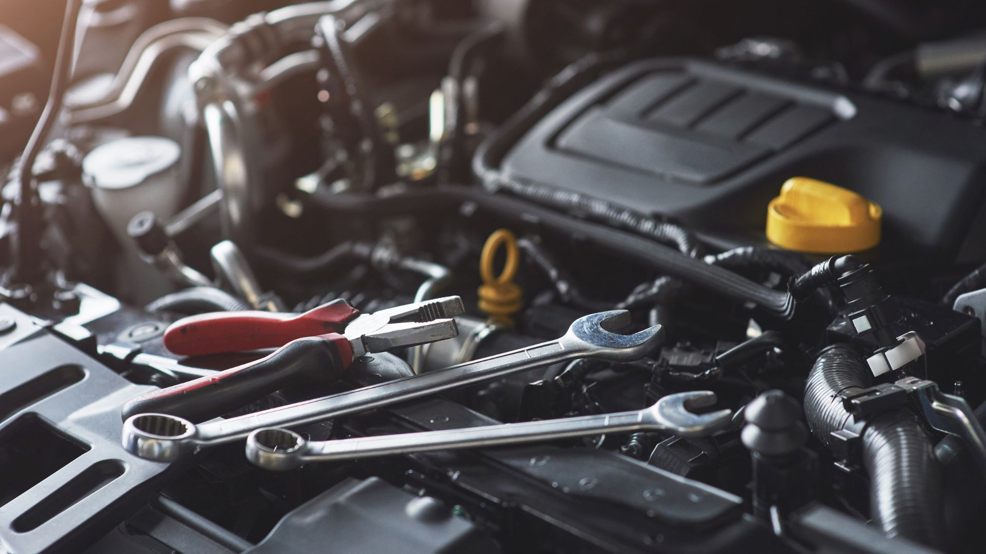 A defective engine with tools surrounding it.